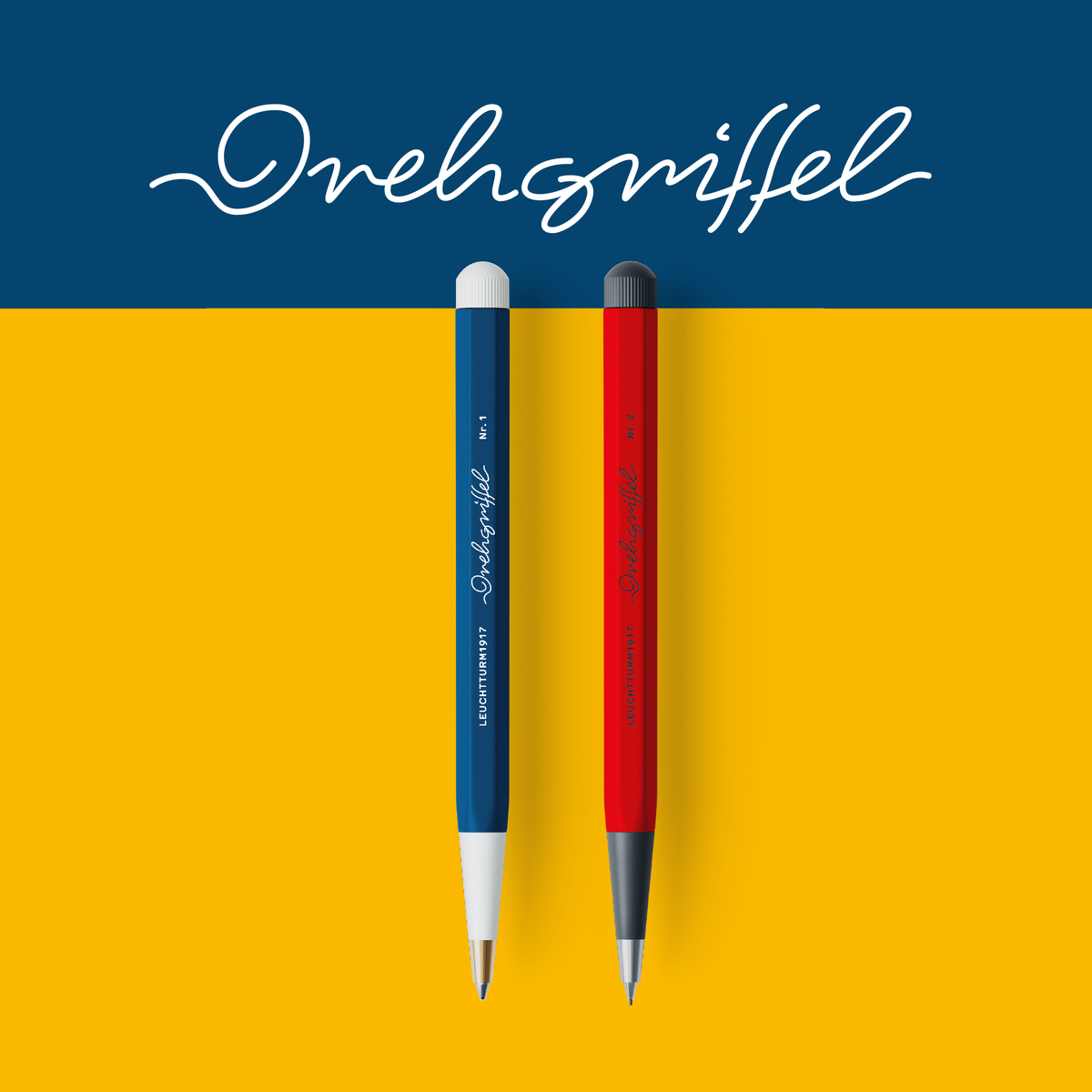 Two pens, one blue and one red, on a yellow background 