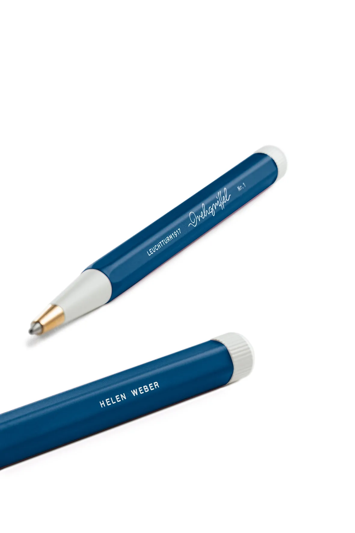 Two blue pens with white accents on a white background