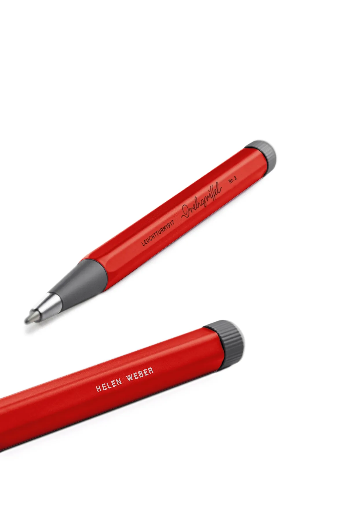 Two red pens with gray accents on a white background