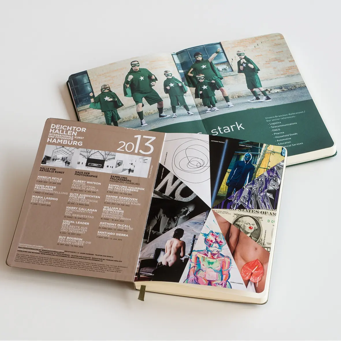 Open notebook with various pages including text and images on a white background