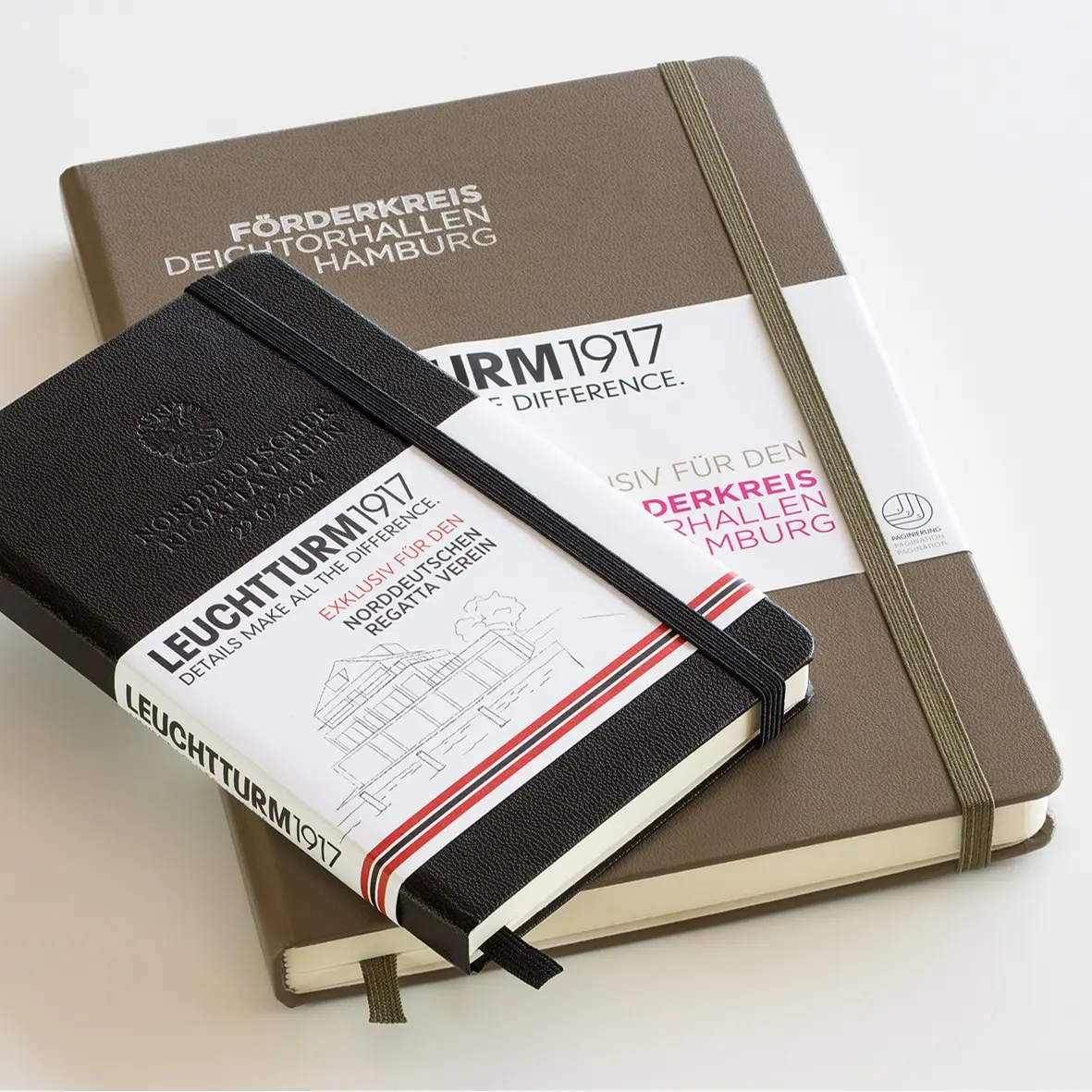 Two notebooks with visible branding on a light background