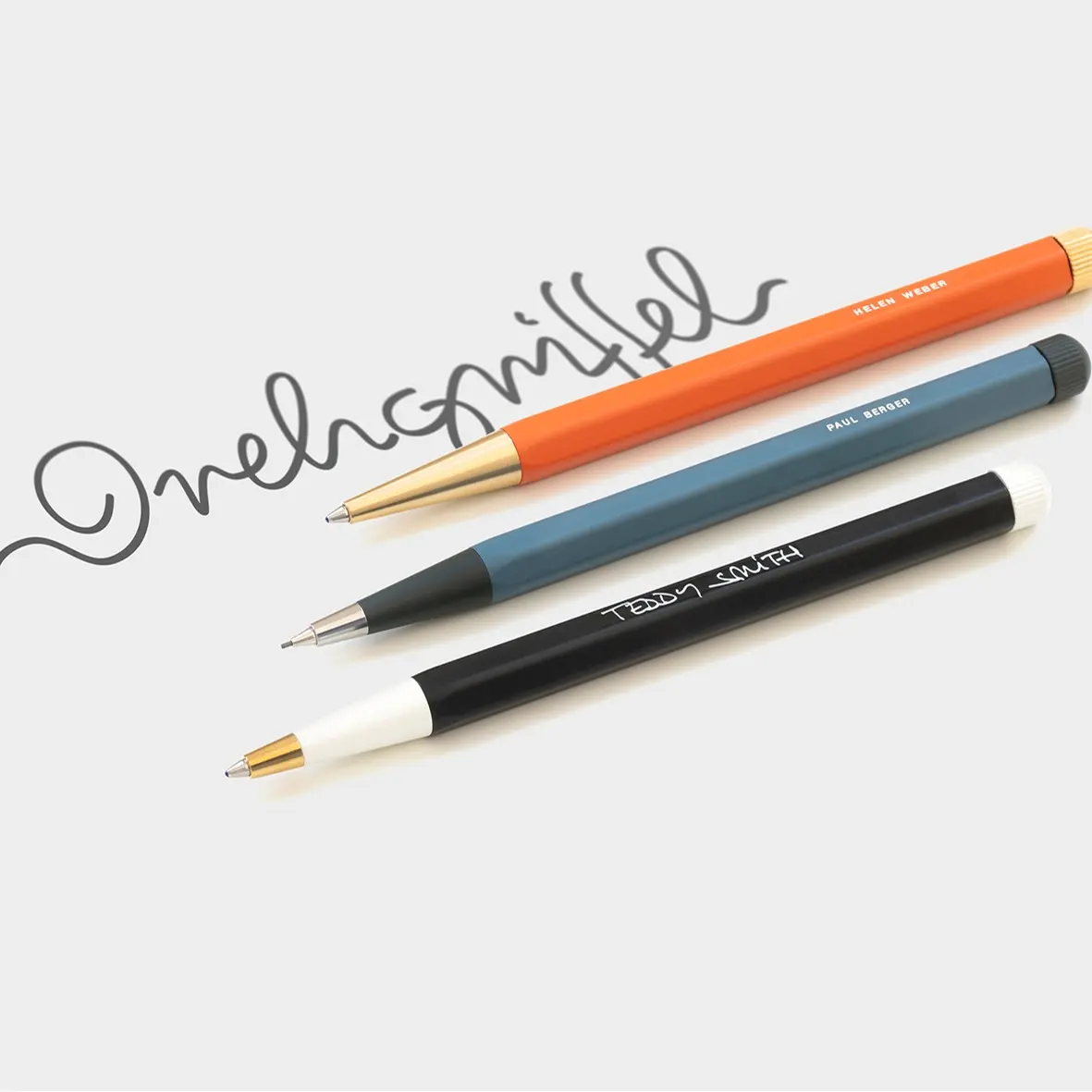 Four pens of different colors and designs on a white background