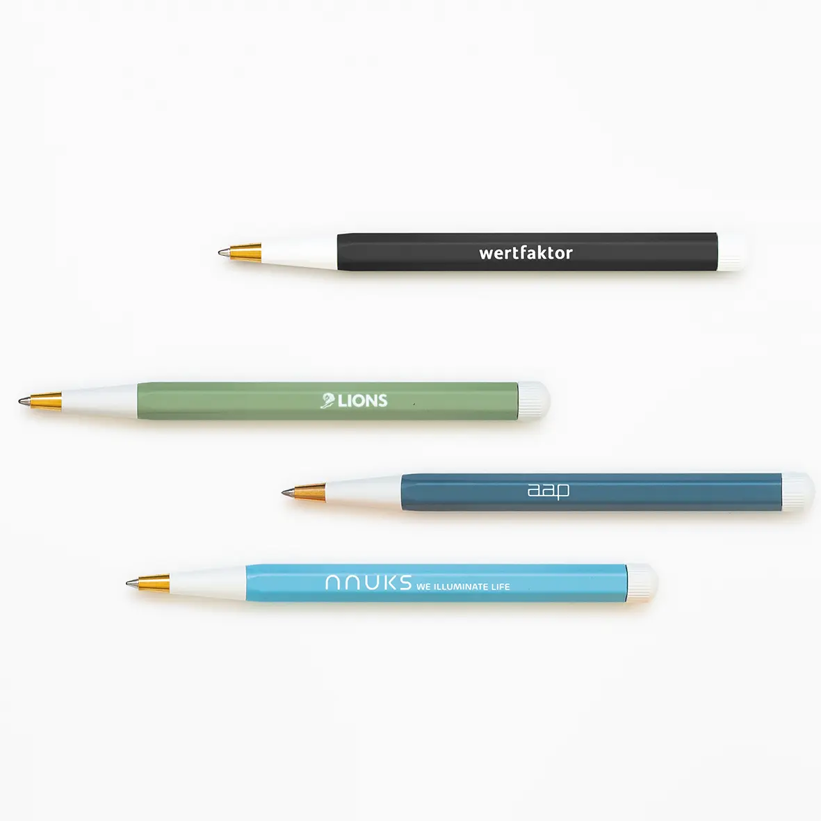 Four pens with different colored bodies and visible branding on a white background