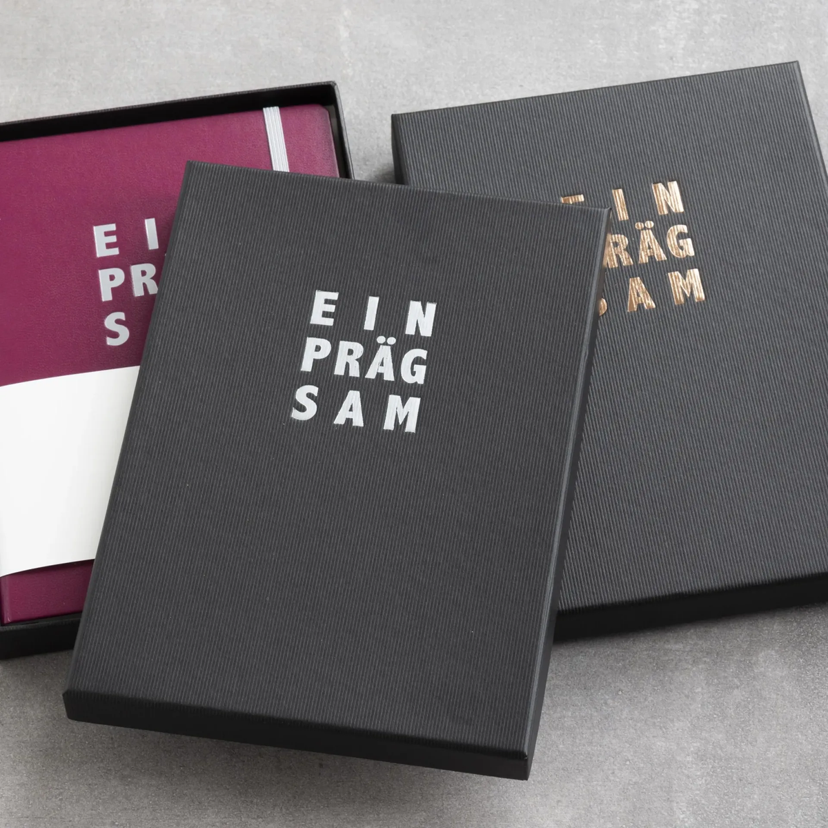 Black boxes with notebooks on a gray surface