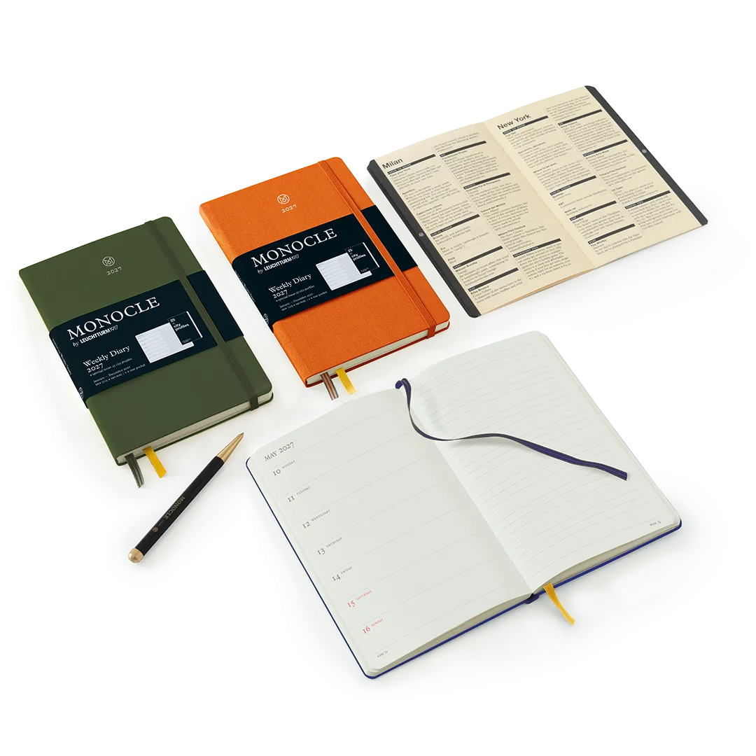 Three notebooks with different covers and open pages on a white background, featuring the brand 'Monocle'.