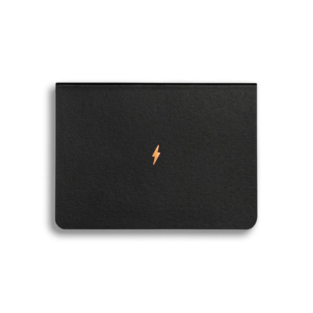 Black notebook with a small orange lightning bolt icon on a white background