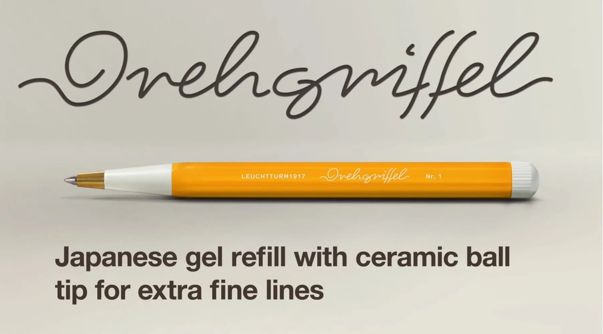Pen with orange body and white cap on a beige background, featuring the brand 'Leuchtturm1917'.