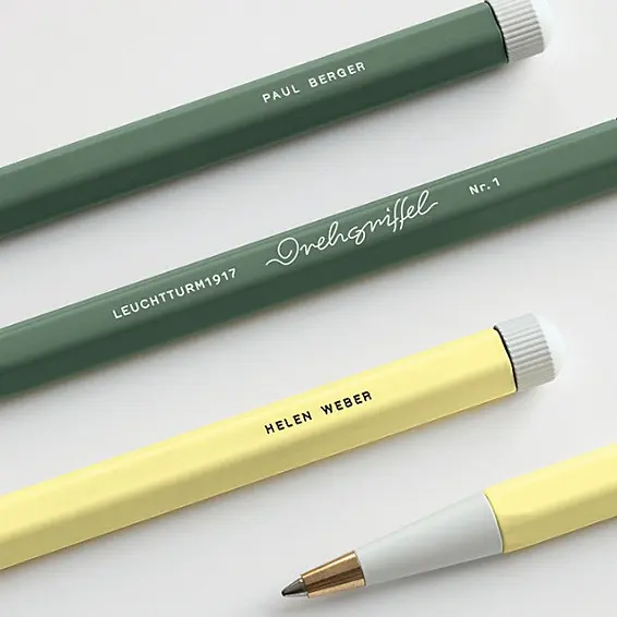 Three pencils with visible branding on a light background