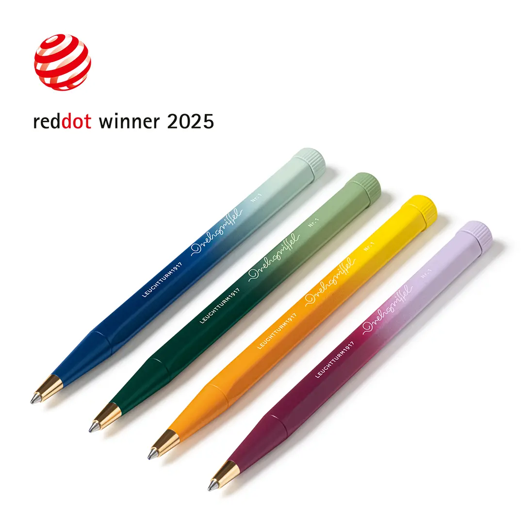 Four colorful pens with a red dot award logo and text on a white background
