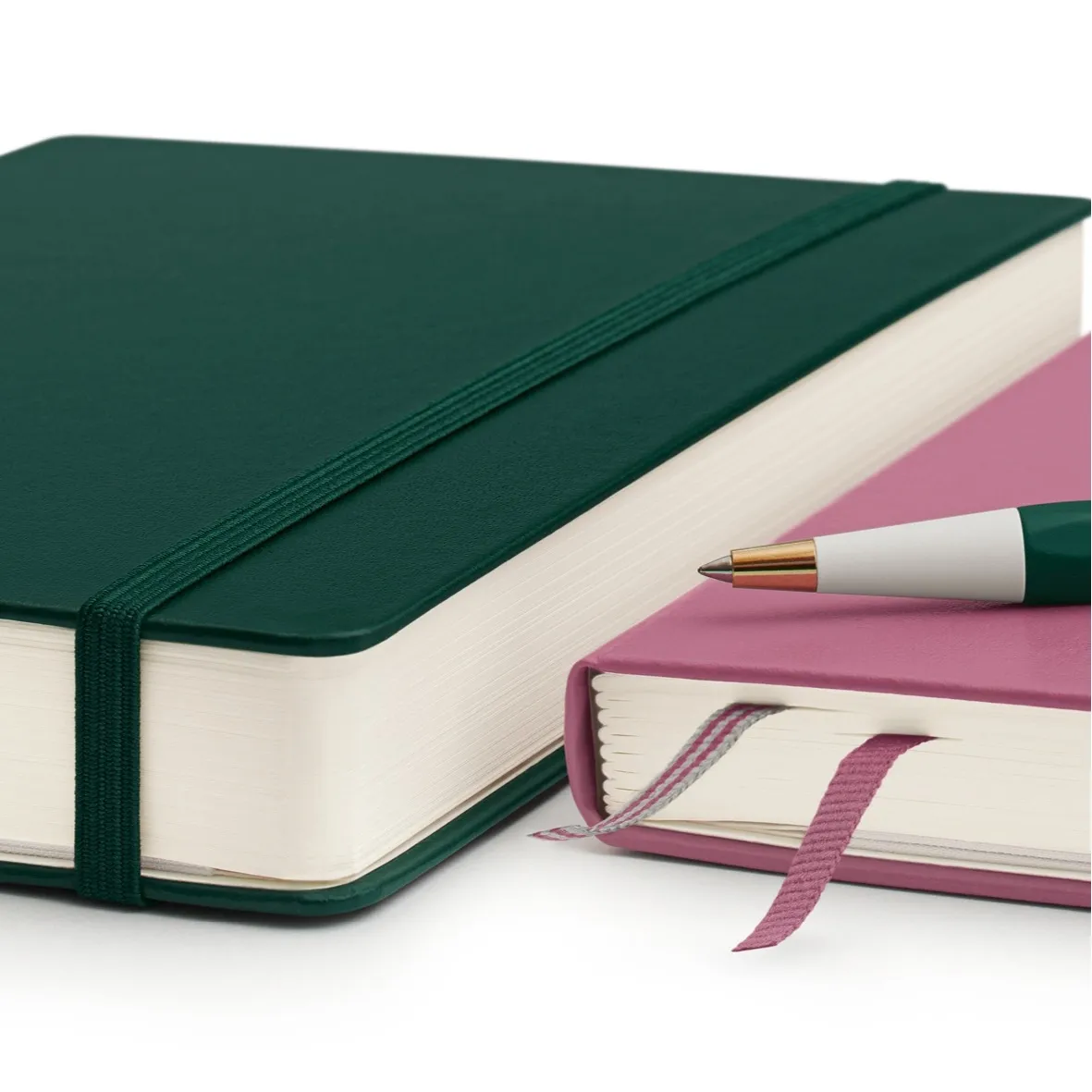 Green and pink notebook with a pen on a white background