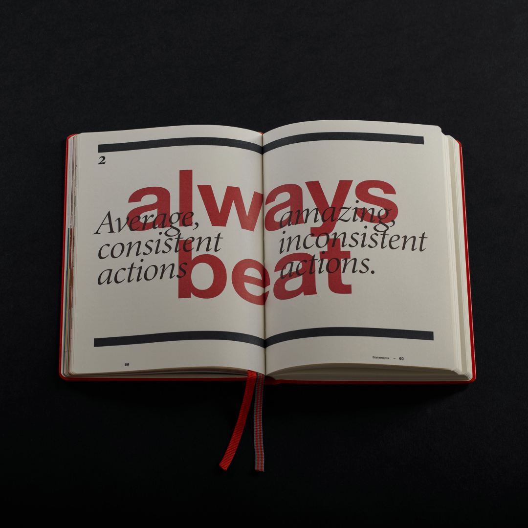 Open book with motivational text on a black background