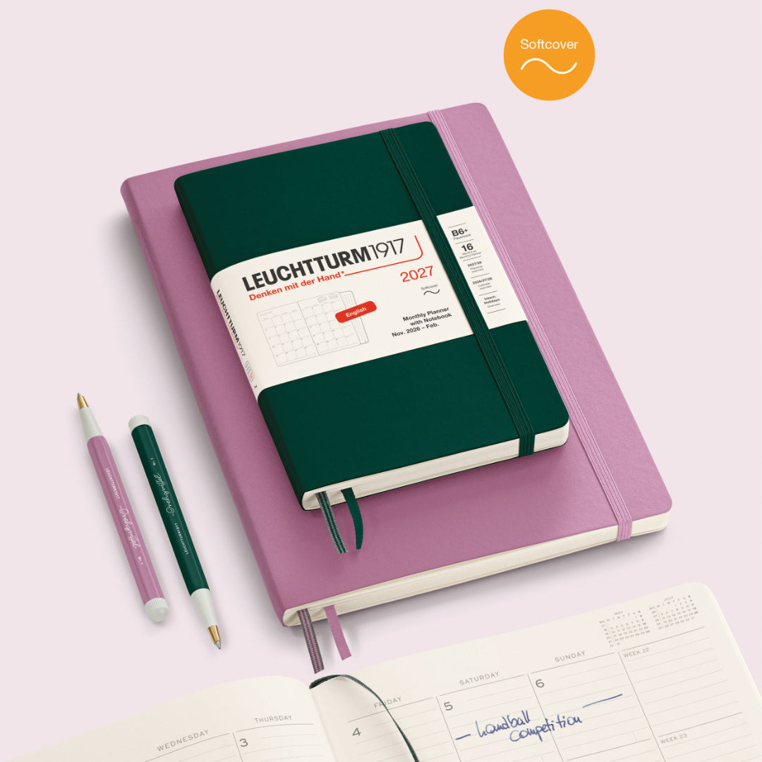 Leuchtturm1917 notebook with pink cover and green interior on a light pink background