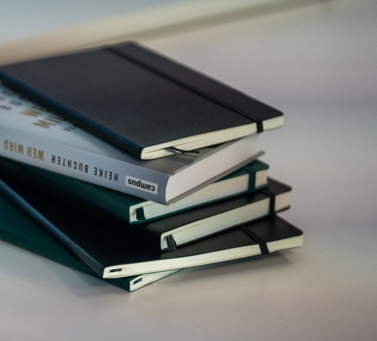 Stack of notebooks on a light surface