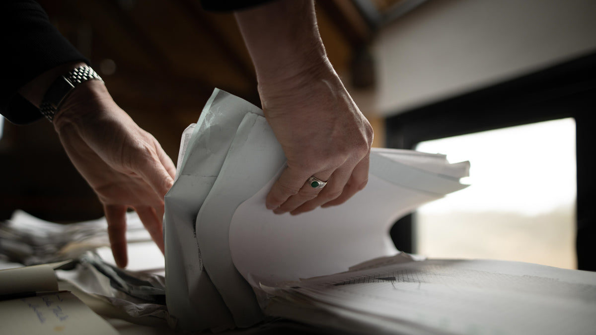 Person handling documents with a blurred background